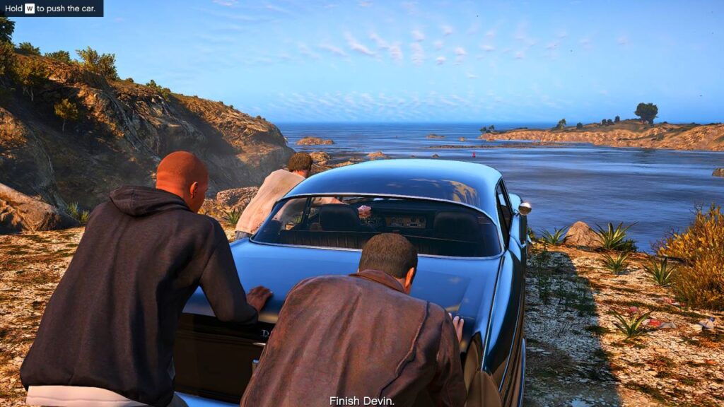 3 protagonists push the car with Devin inside to the ocean